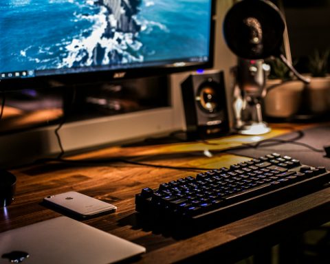 black corded gaming computer keyboard and flat screen monitor