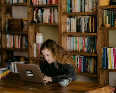 woman in black long sleeve shirt using macbook