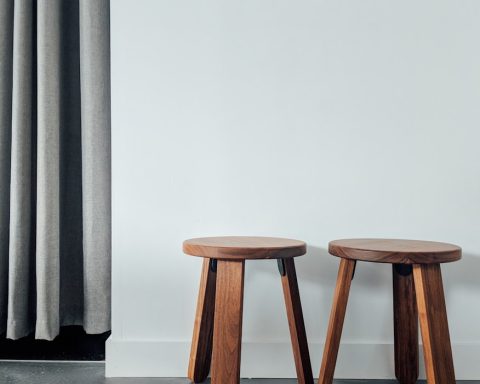 two brown wooden stools